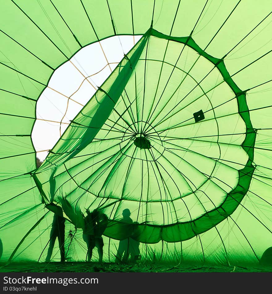 People fixing hot air balloon