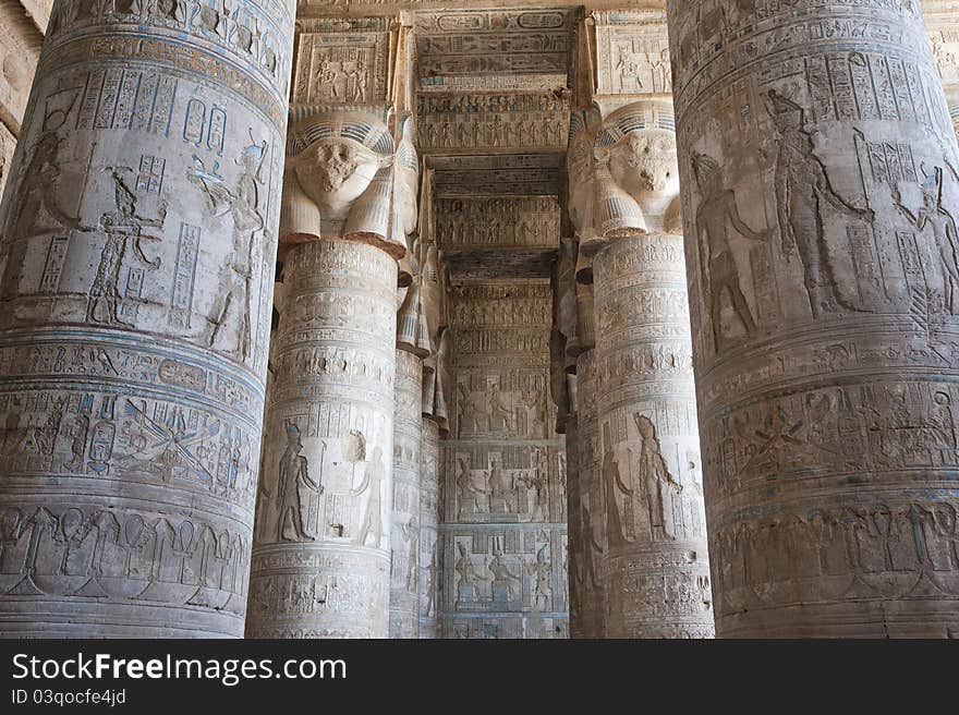 Columns inside an ancient egyptian temple covered in hieroglyphic carvings and paintings. Columns inside an ancient egyptian temple covered in hieroglyphic carvings and paintings