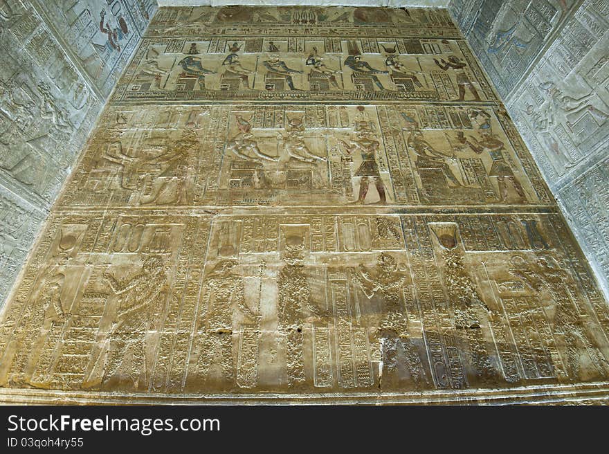 Hieroglyphic carvings and paintings on the interior walls of an ancient egyptian temple. Hieroglyphic carvings and paintings on the interior walls of an ancient egyptian temple