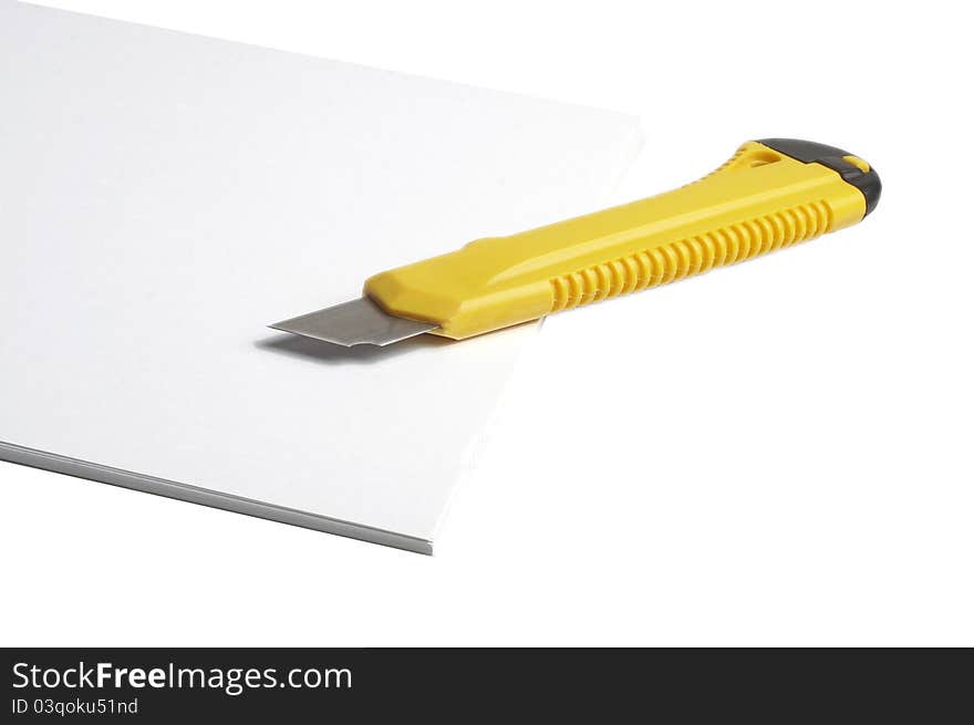 Yellow paper knife and paper stack on white background. Yellow paper knife and paper stack on white background