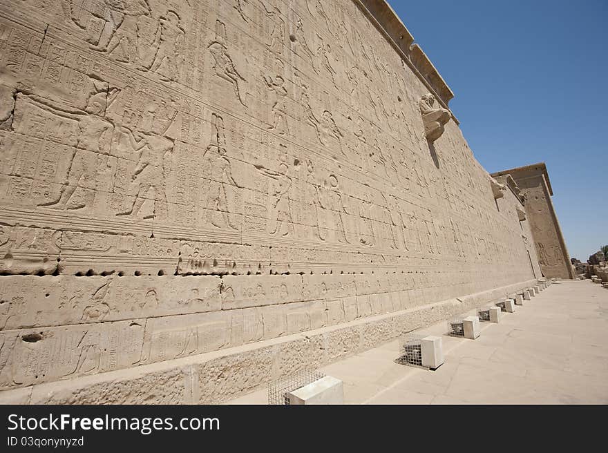 Hieroglyphic carvings on the exterior walls of an ancient egyptian temple. Hieroglyphic carvings on the exterior walls of an ancient egyptian temple