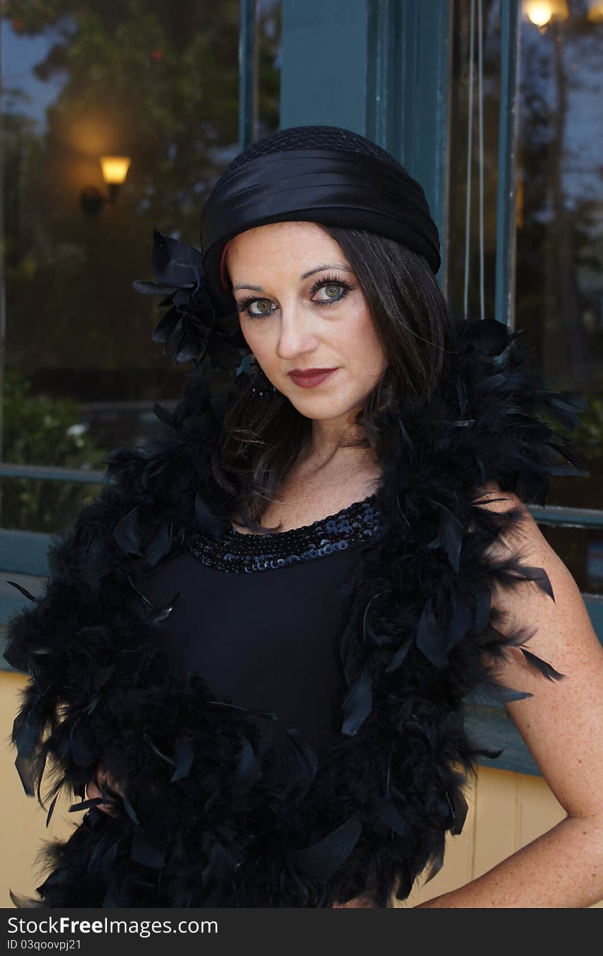 Beautiful Woman modeling clothing and accessories from 1930/40's Vintage clothing, hat, and a boa standing at old train station waiting to train. Beautiful Woman modeling clothing and accessories from 1930/40's Vintage clothing, hat, and a boa standing at old train station waiting to train