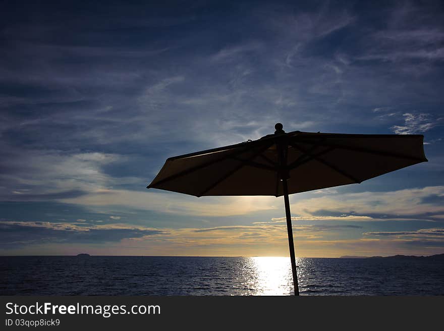 Silhouette umbrella on the beach and beautiful blue sky, sunset. Silhouette umbrella on the beach and beautiful blue sky, sunset