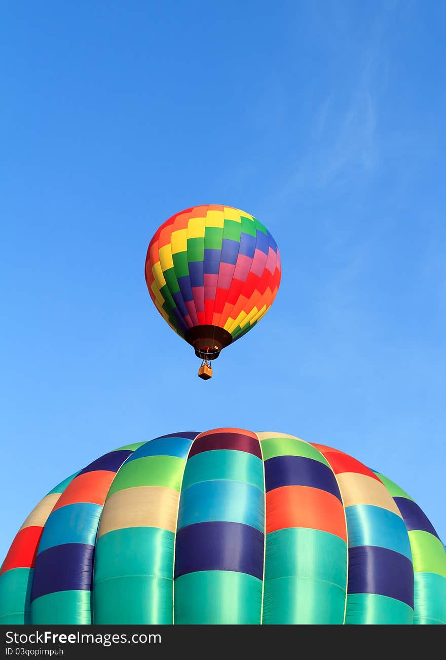 Two hot air balloons over blue sky