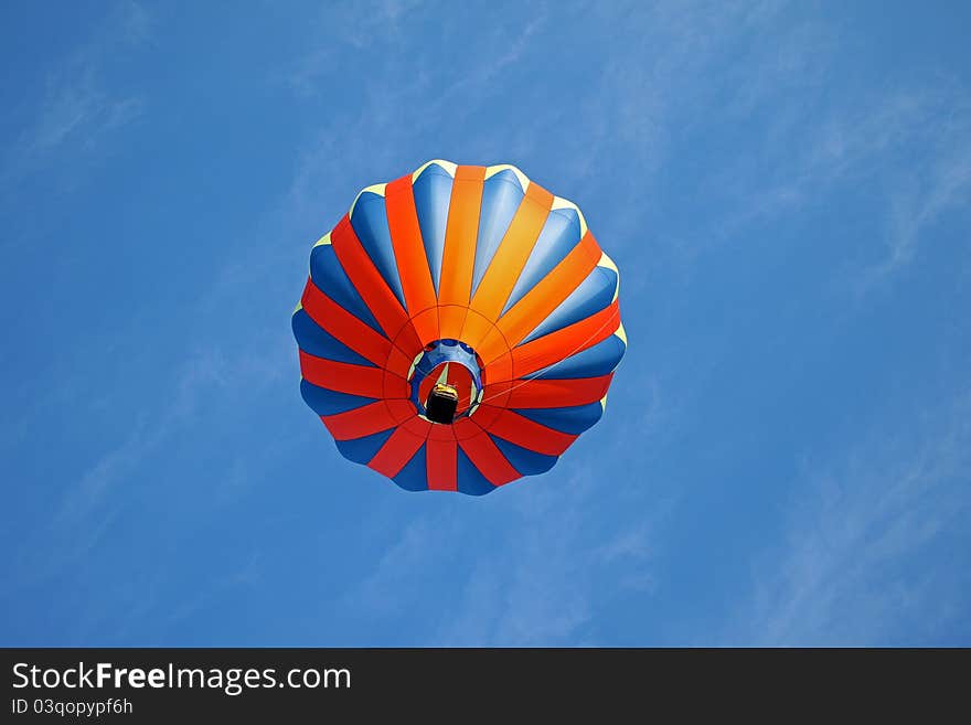 Hot air balloon on light blue background with red blue and yellow highlights. Hot air balloon on light blue background with red blue and yellow highlights.