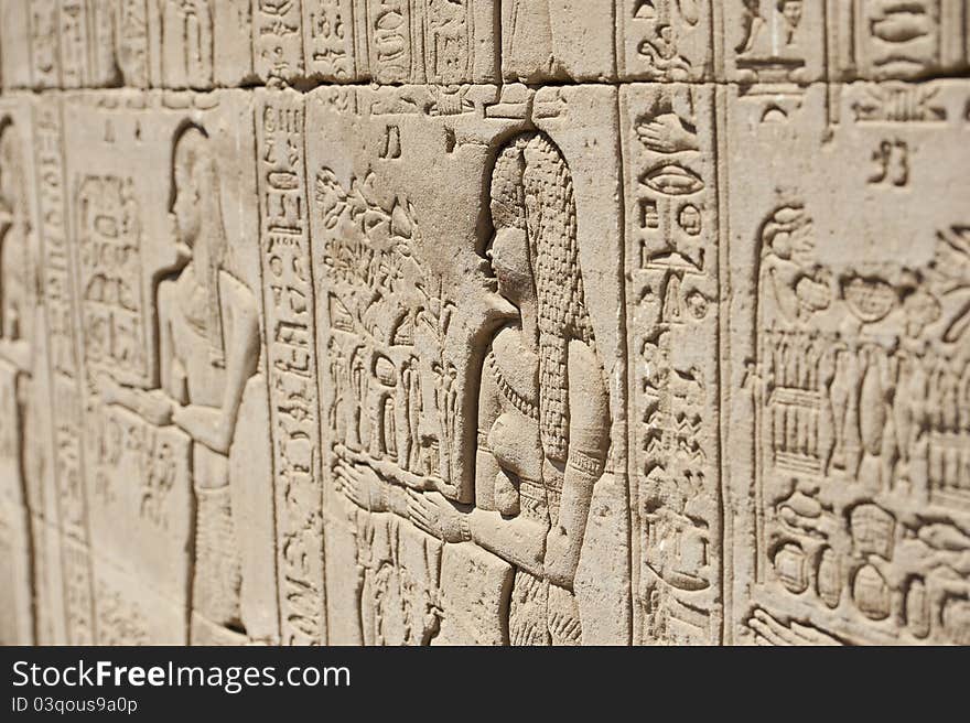 Hieroglyphic carvings on the exterior walls of an ancient egyptian temple. Hieroglyphic carvings on the exterior walls of an ancient egyptian temple