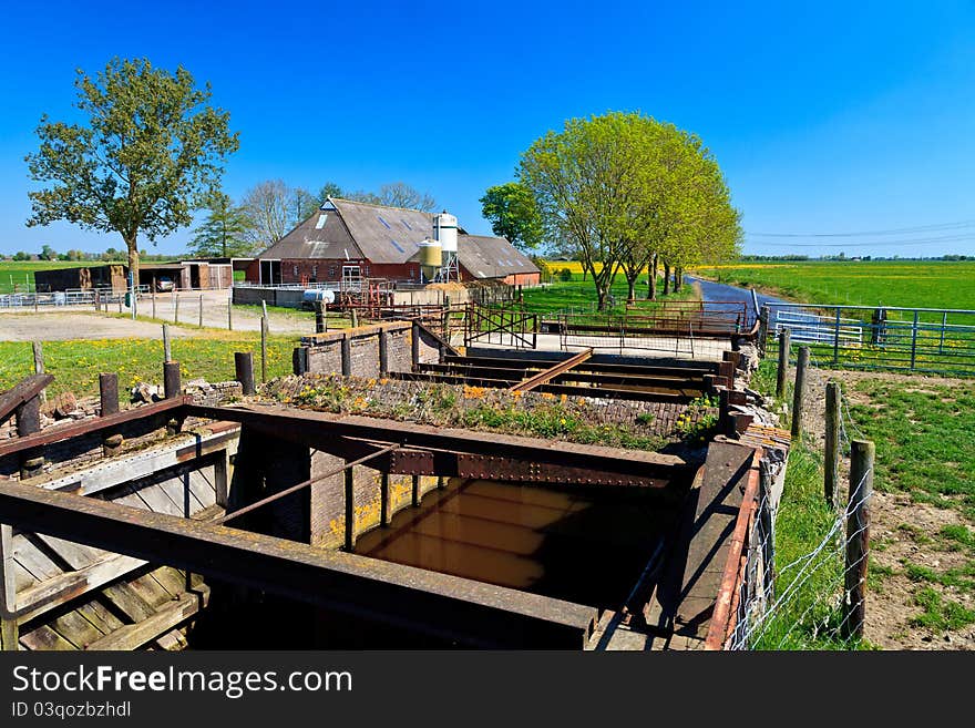 Farm with stream in the countryside on a sunny day