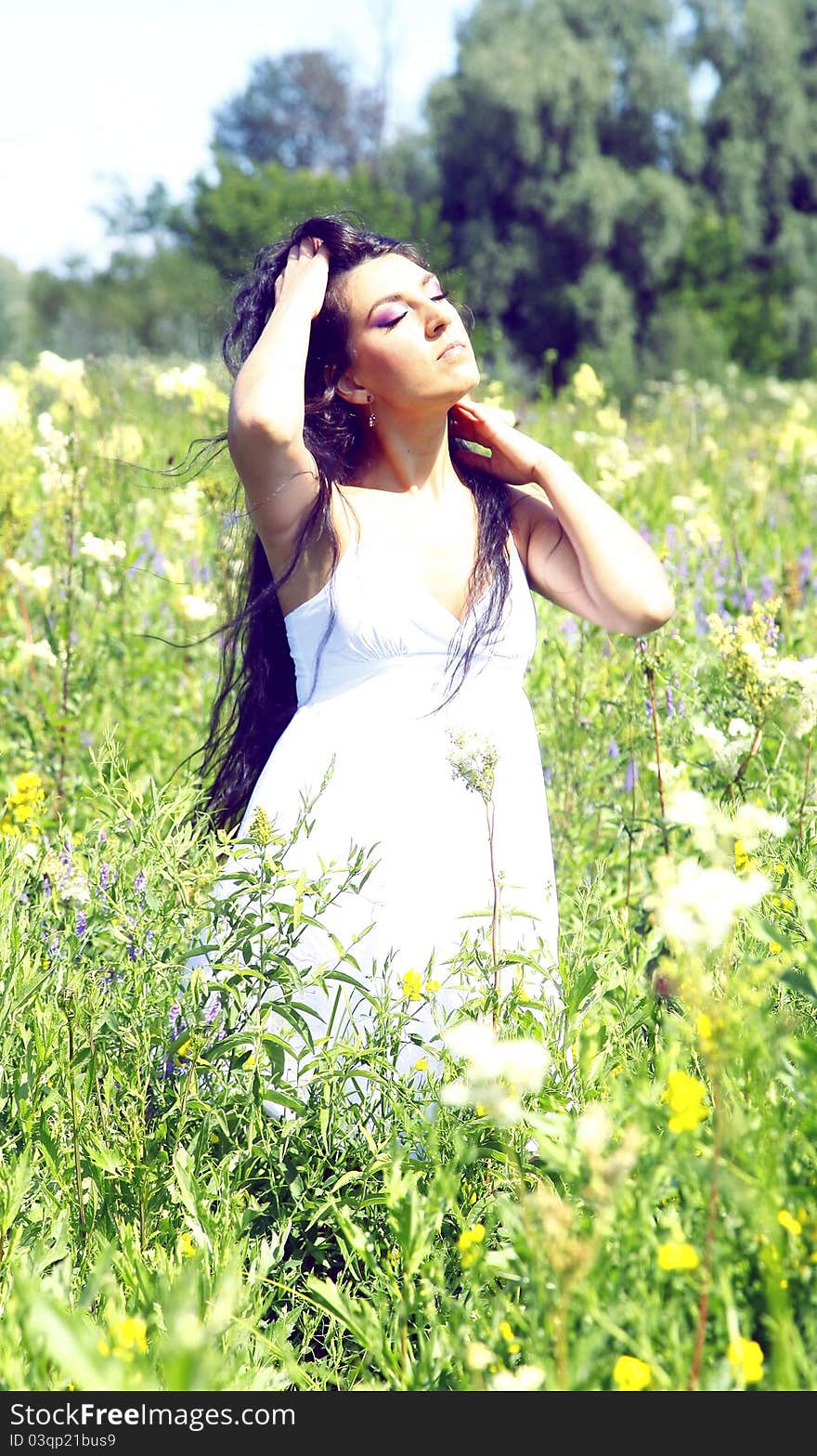 Girl in the flowers with long beautiful hair. Girl in the flowers with long beautiful hair