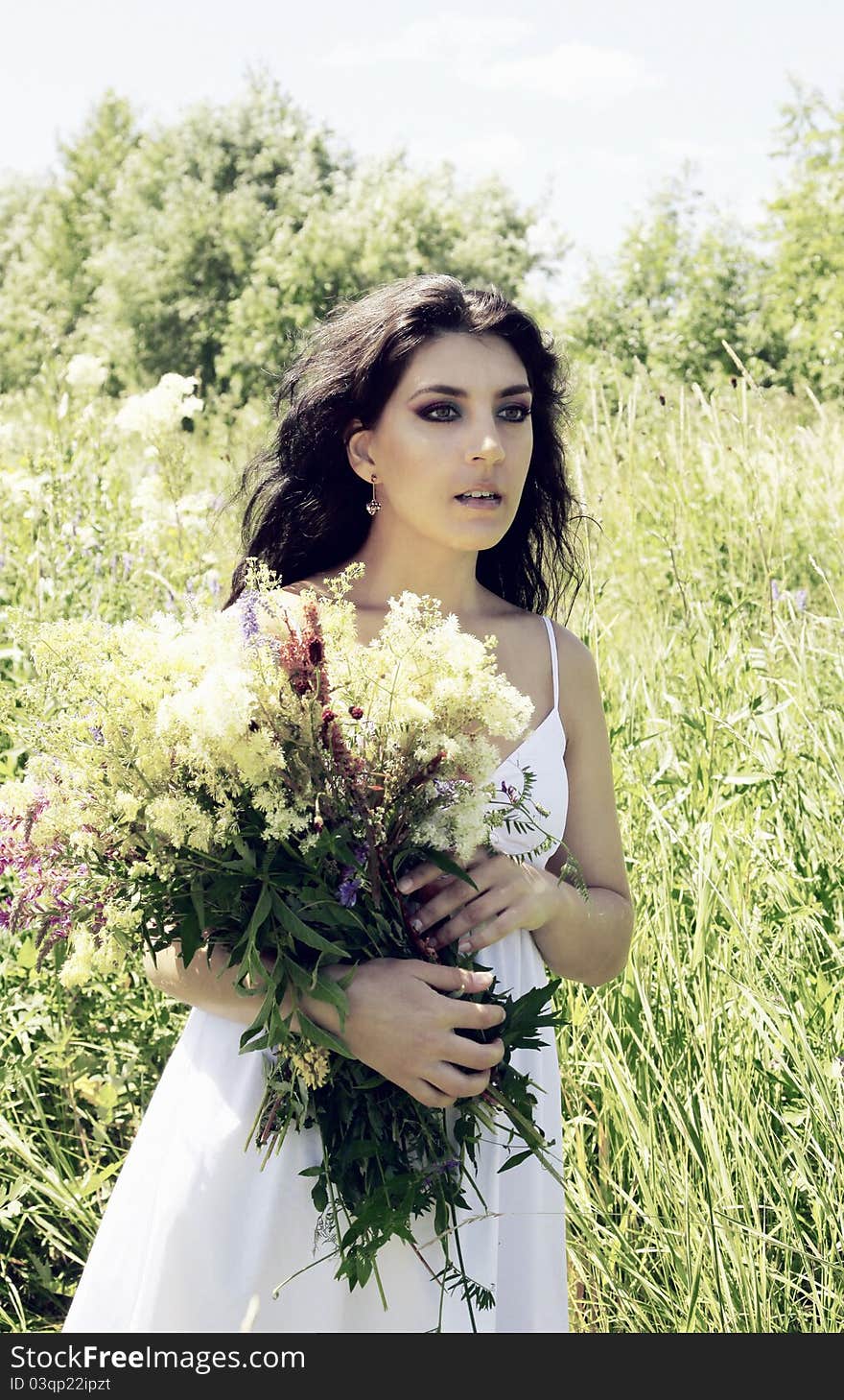 Girl in the flowers with long beautiful hair. Girl in the flowers with long beautiful hair