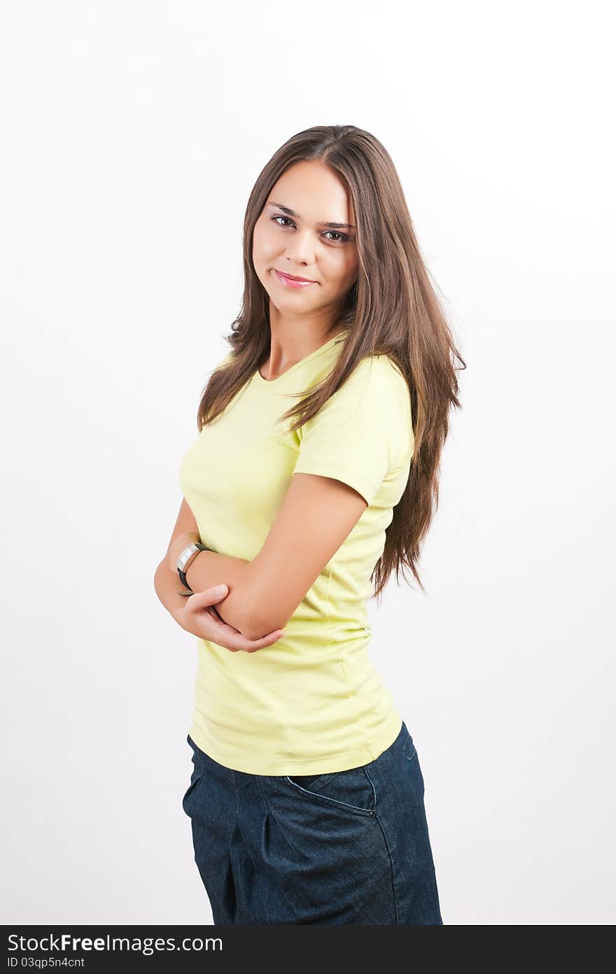 Confident woman with arms crossed against a white background