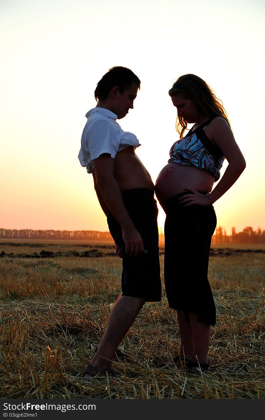 The pregnant girl and the guy are measured by stomachs