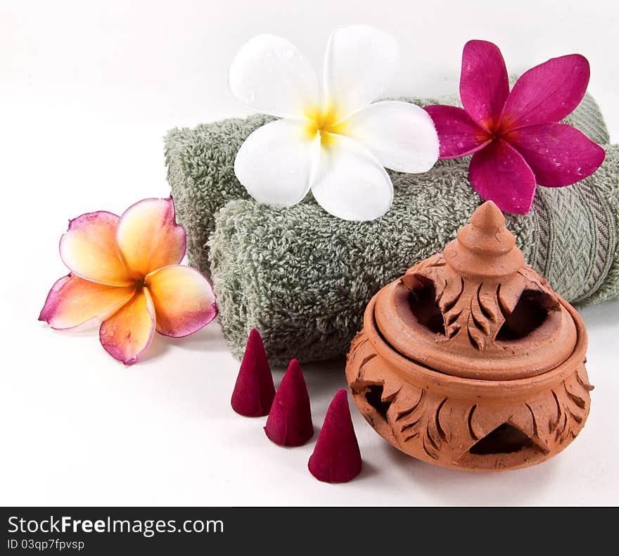 Spa accessories: Rolled towel, pampering stuff and frangipani flowers. Spa accessories: Rolled towel, pampering stuff and frangipani flowers.