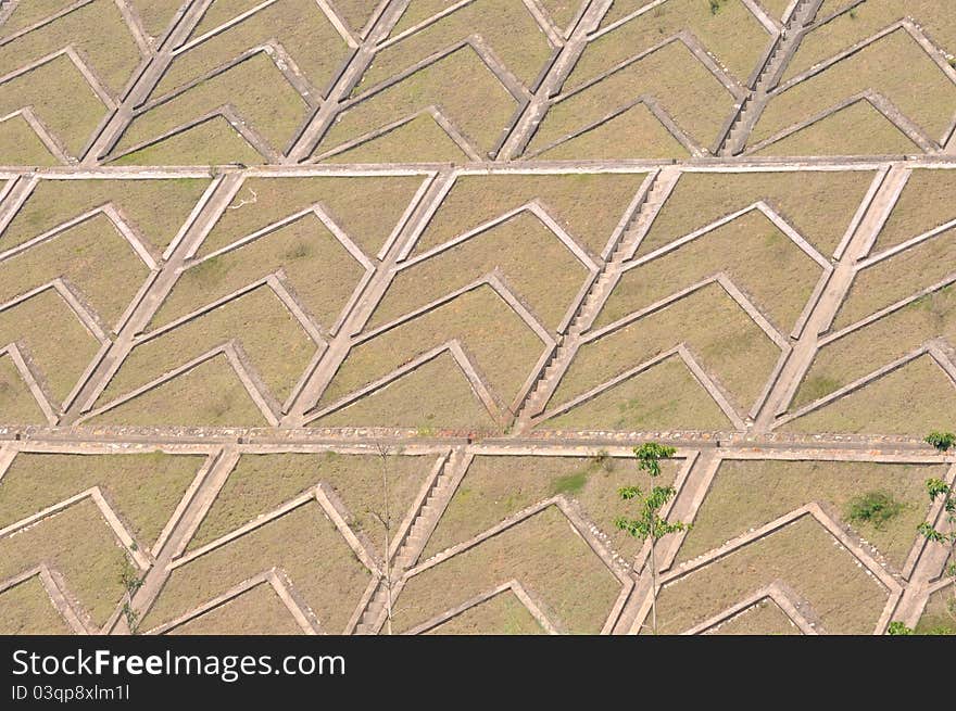 Concrete laying counterfort of water dam slope, with grass surface, shown as industrial architecture or featured background. Concrete laying counterfort of water dam slope, with grass surface, shown as industrial architecture or featured background.