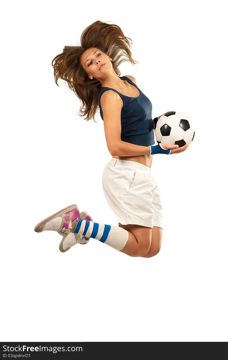 Girl jumpig with soccer ball in mid air with over white background