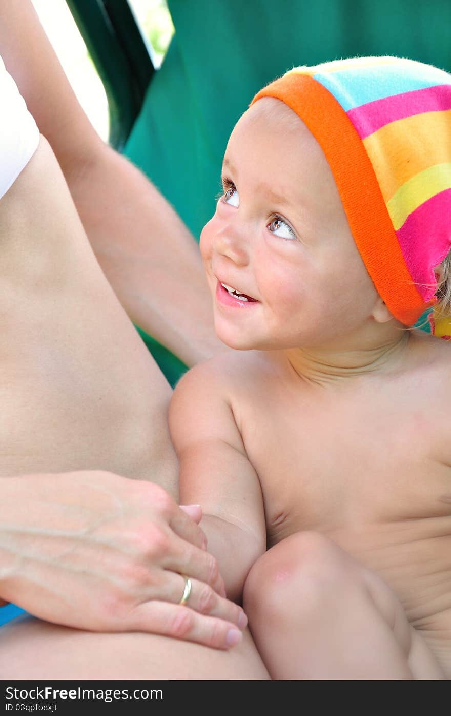 Baby Smiling And Looking At Mother