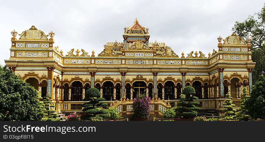 Facade of Vĩnh Tràng Buddhist Temple (largest Pagoda in the Mekong Delta) located in My Tho, Vietnam, Asia