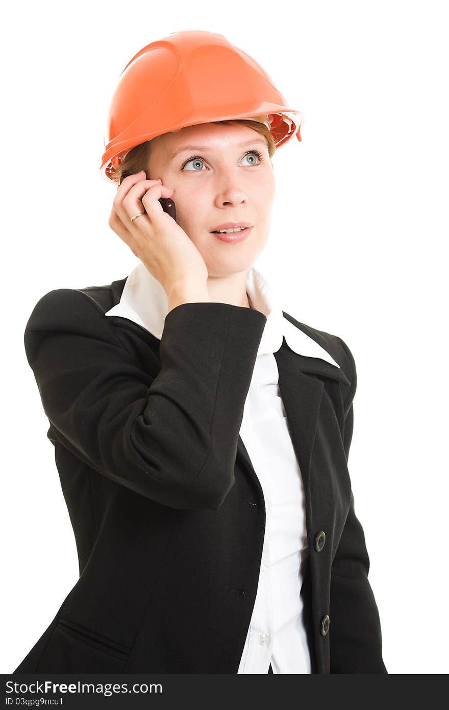 Businesswoman in a helmet with a mobile phone on a white background. Businesswoman in a helmet with a mobile phone on a white background.