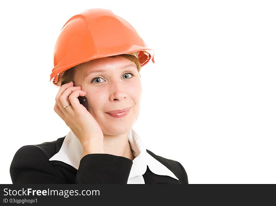 Businesswoman in a helmet with a mobile phone on a white background. Businesswoman in a helmet with a mobile phone on a white background.