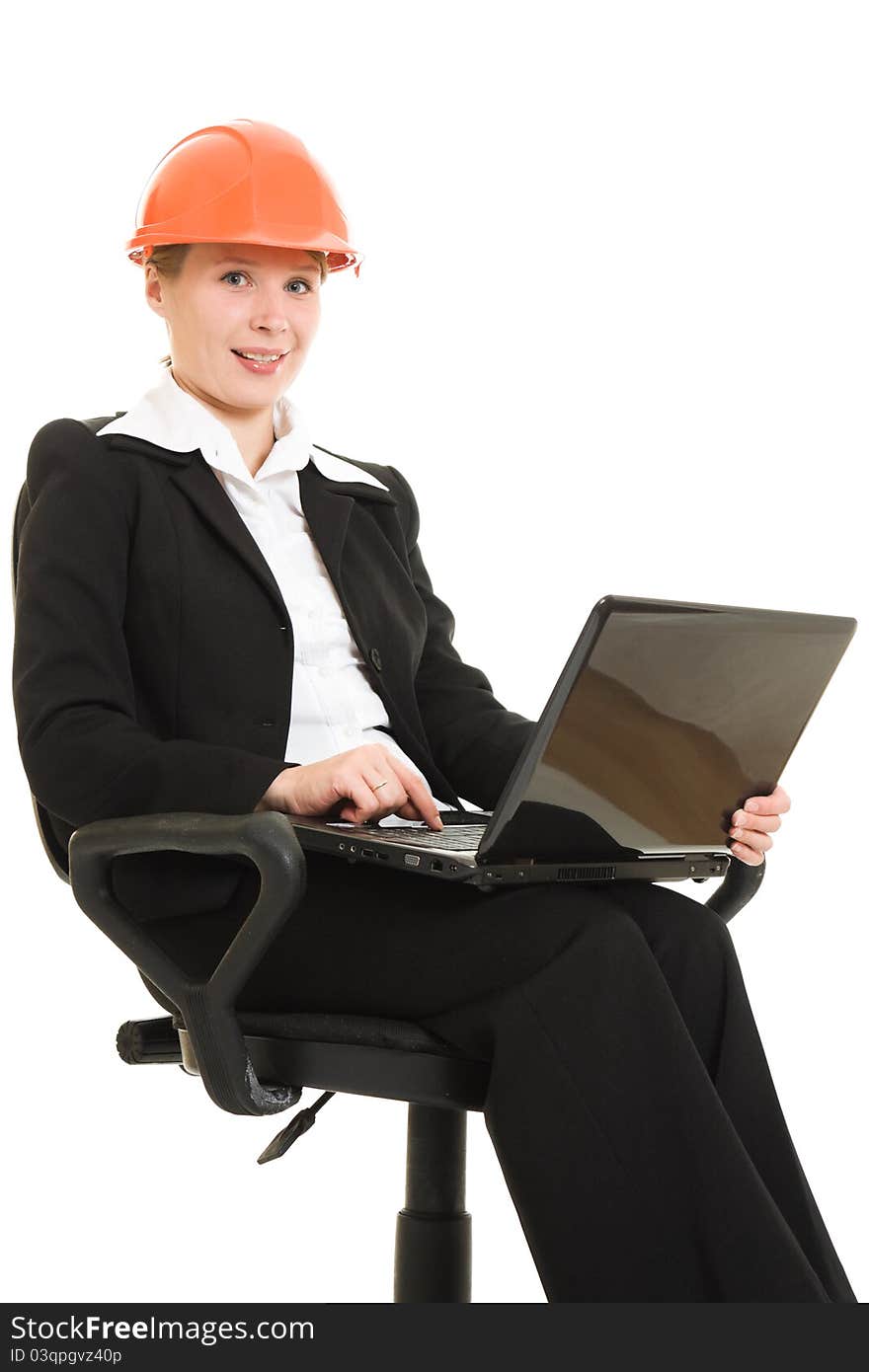 Businesswoman wearing a helmet with a laptop on a white background.