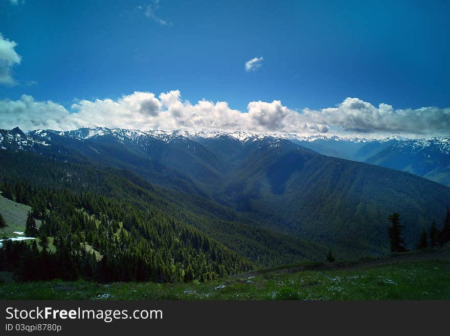 Snow peninsula mountain panorama with clouds and trees in summer. Snow peninsula mountain panorama with clouds and trees in summer.