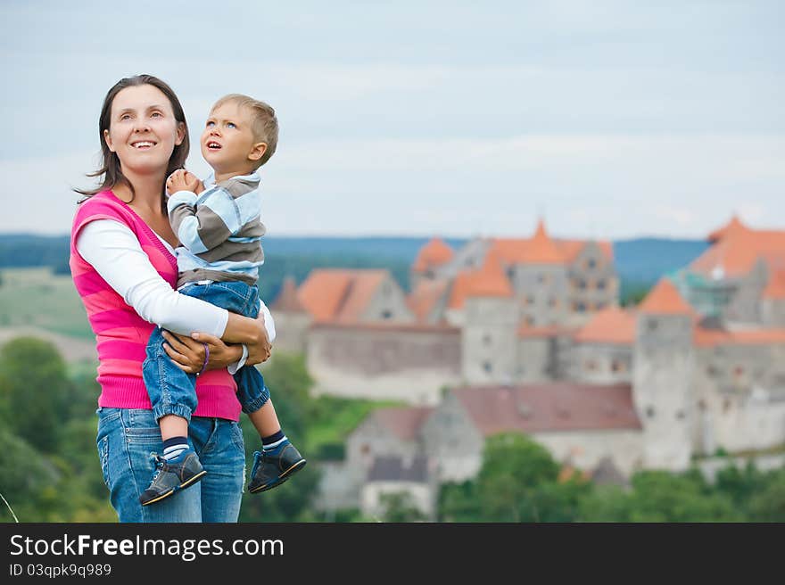 Young travelers. Young mother with her son on a tour of European medieval castles.