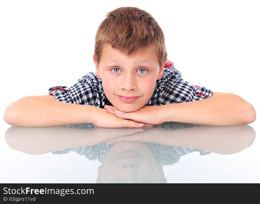 Schoolboy leaning on school desk