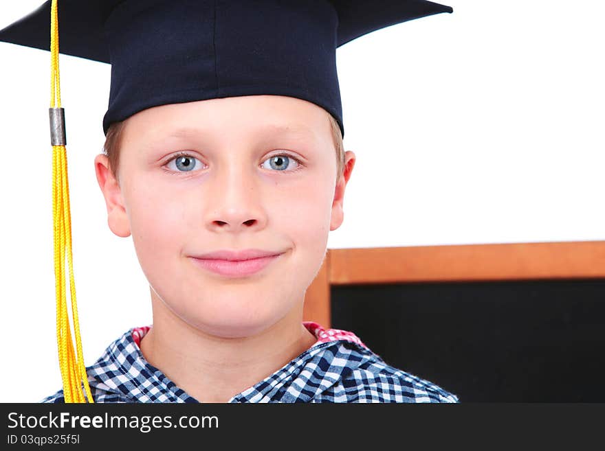 Graduate boy in cap with blackboard in background