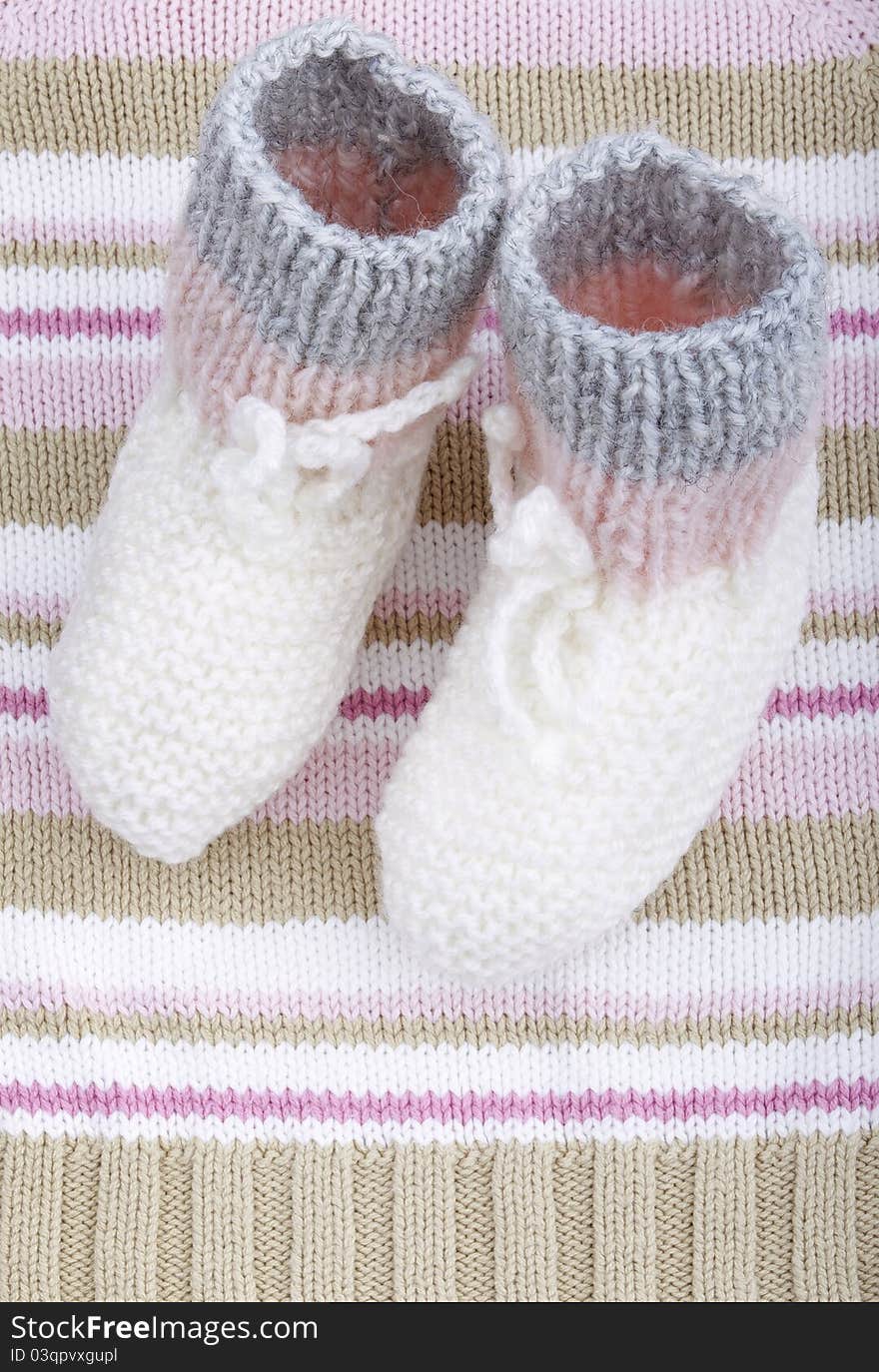 Studio-shot of selfmade hand-knitted woolen baby socks.