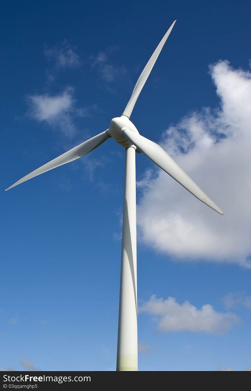 Vertical wind generator on a blue sky background