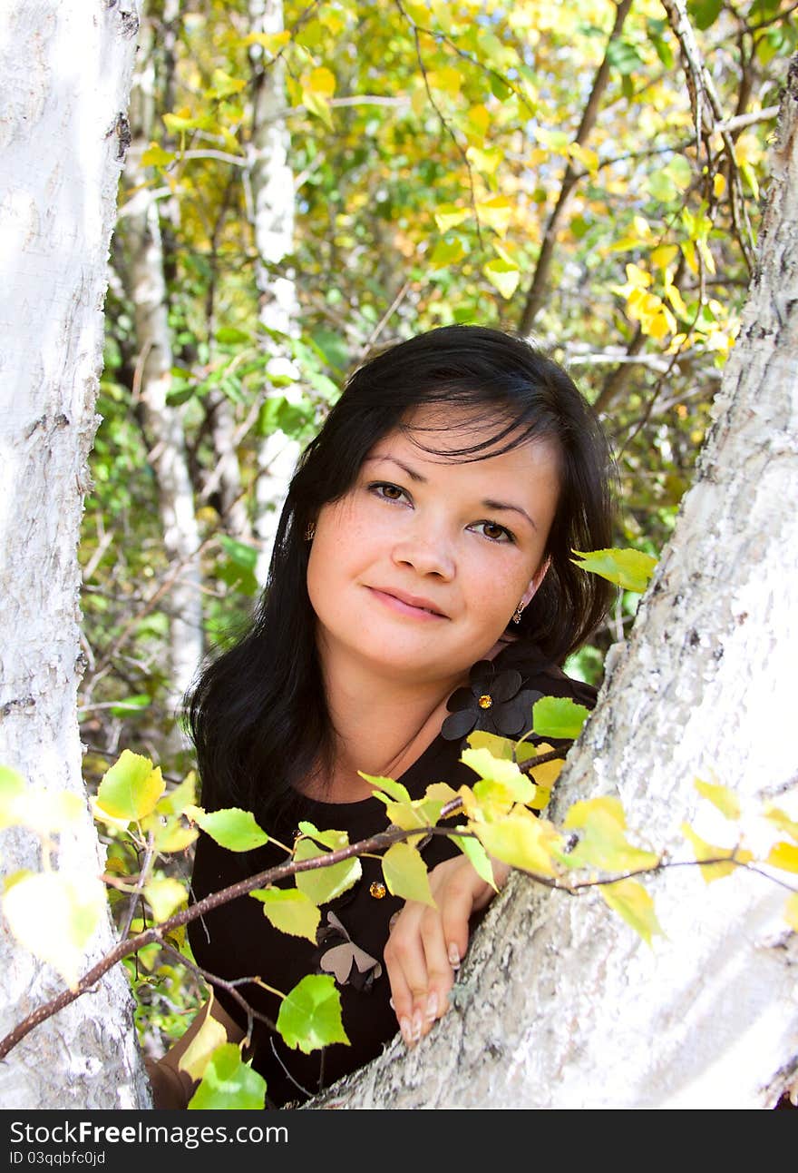 Portrait young smiling girl in a forest