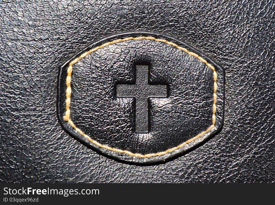 A photo of the cross of Jesus on leather. A photo of the cross of Jesus on leather.