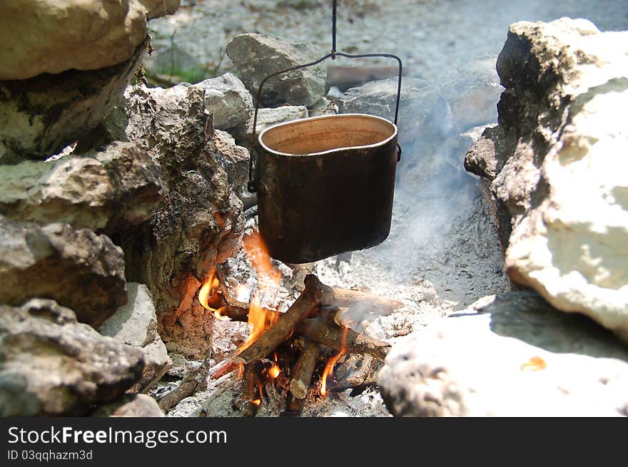 A kettle on a camp fire