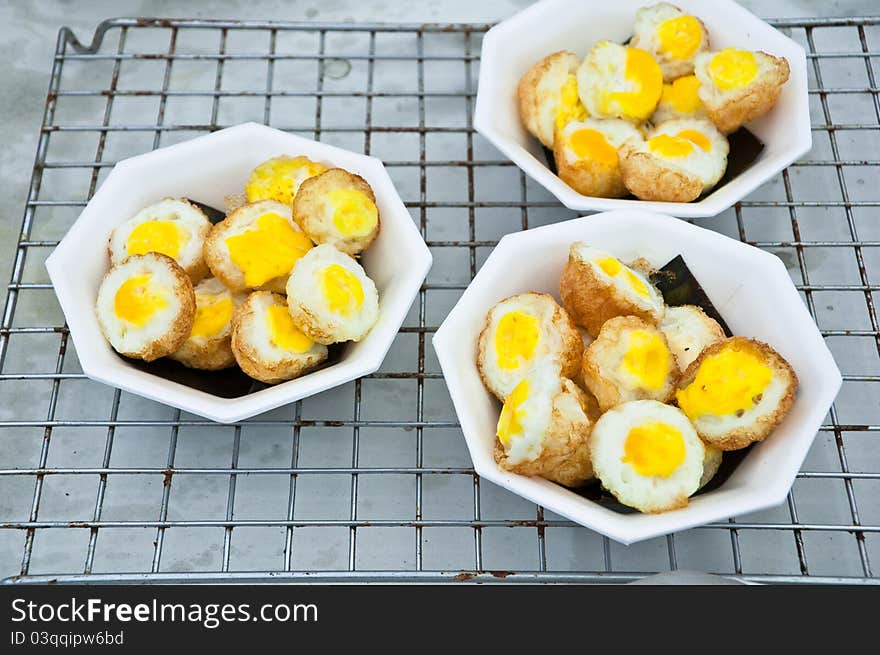 Boiled egg with fried on foam cups.