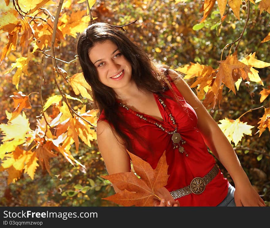 Attractive young girl having fun in autumn park. Attractive young girl having fun in autumn park