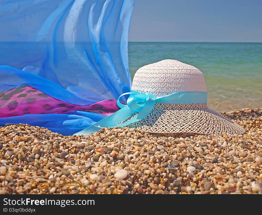 Straw Hat And Pareo On A Beach