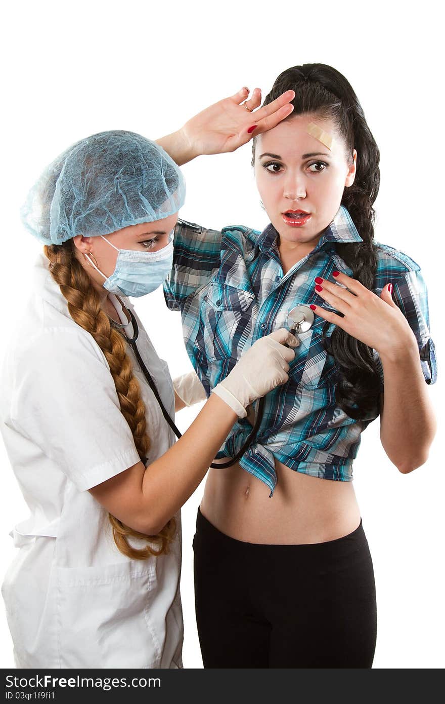 Beautiful nurse listens to the chest phonendoscope girl on a white background. Beautiful nurse listens to the chest phonendoscope girl on a white background