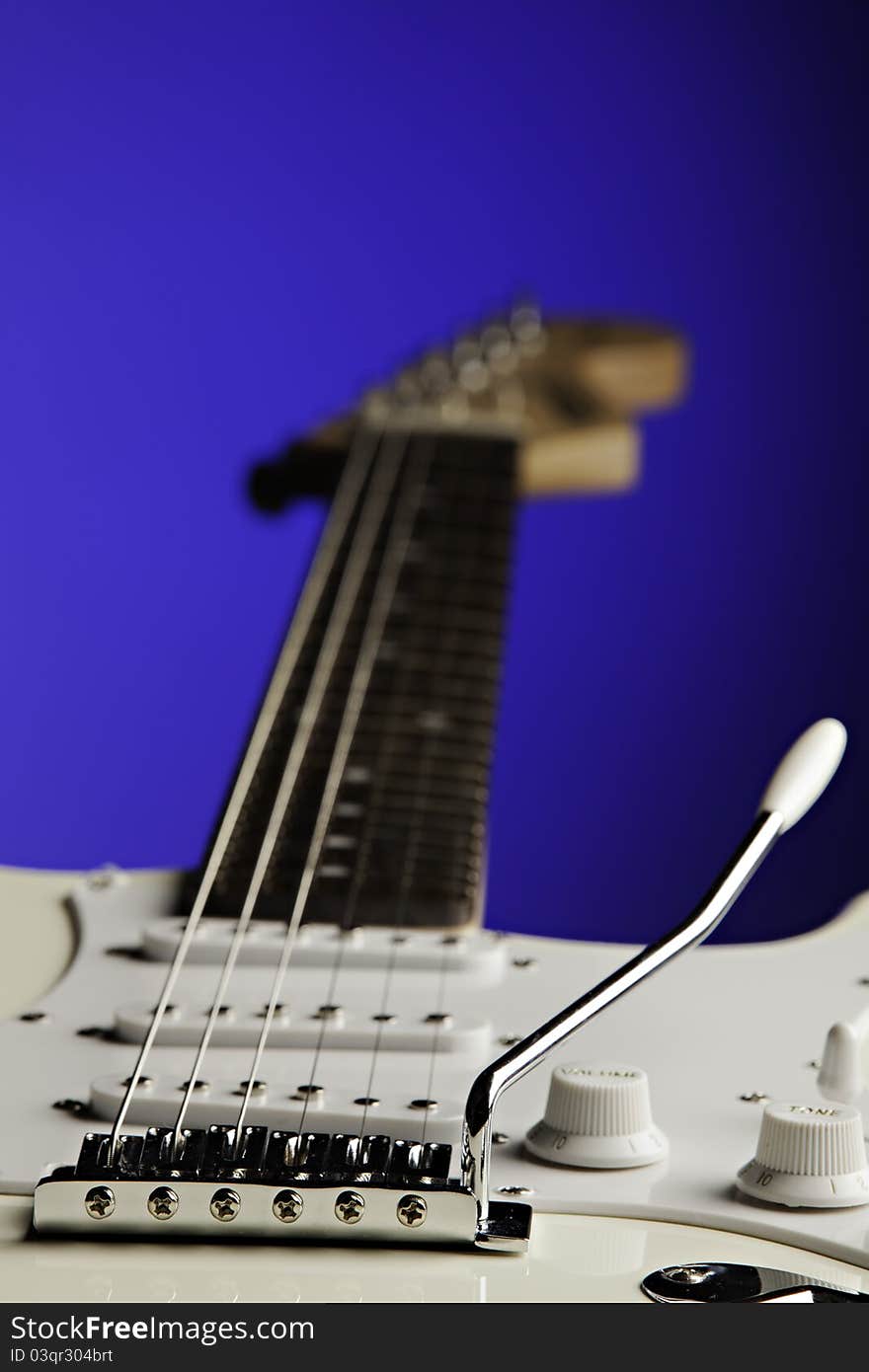 White Guitar Isolated On Blue