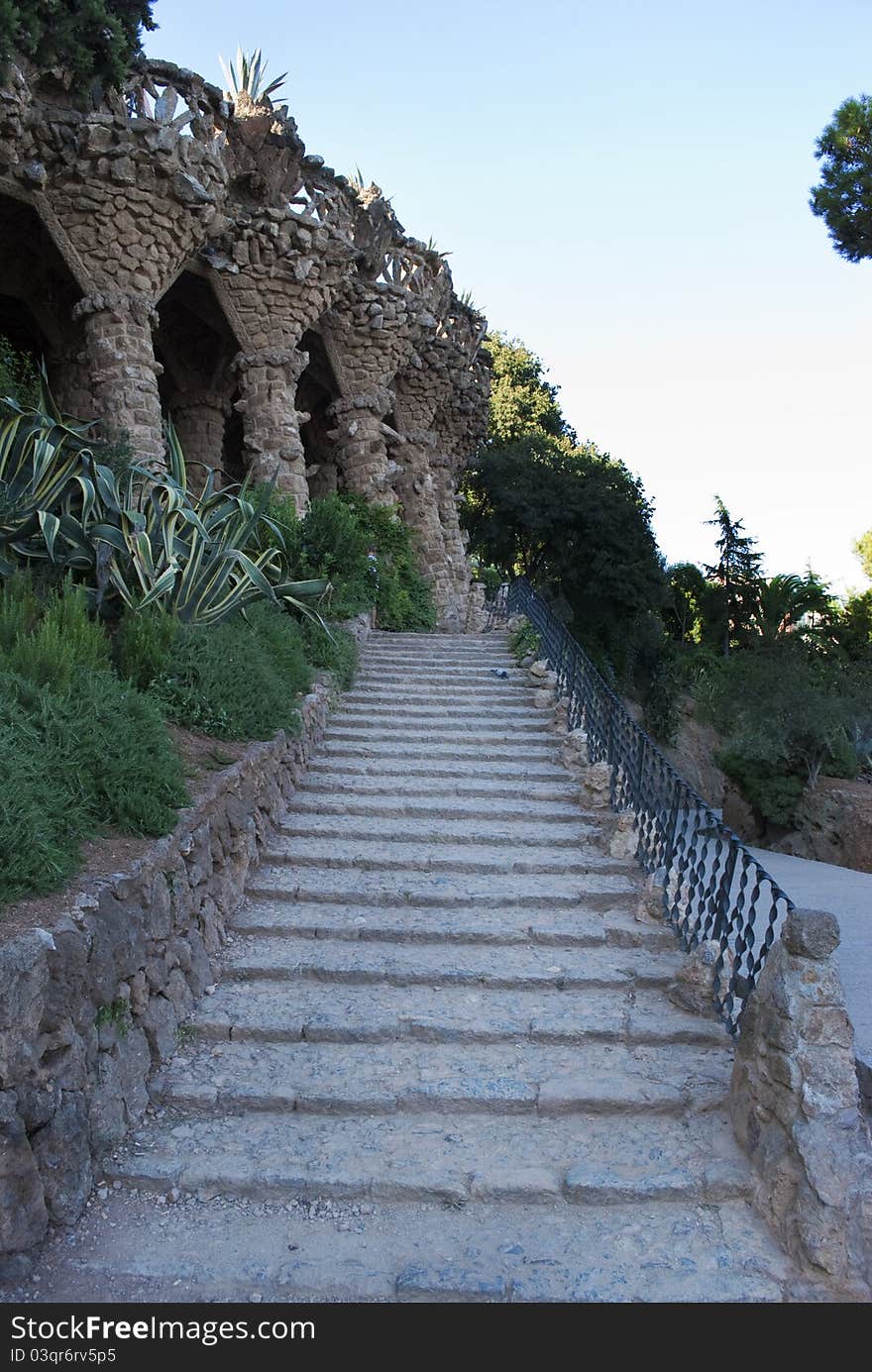 An outdoor stairs made of stones,visitable in the Park Guell in Barcelona