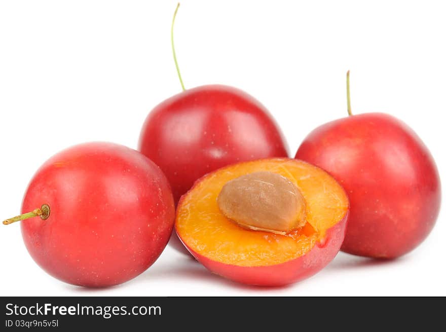 Red cherry plums on white background