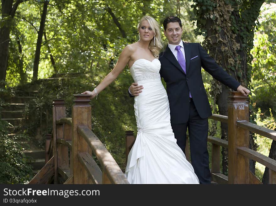 Love on the wooden bridge in Green Forest