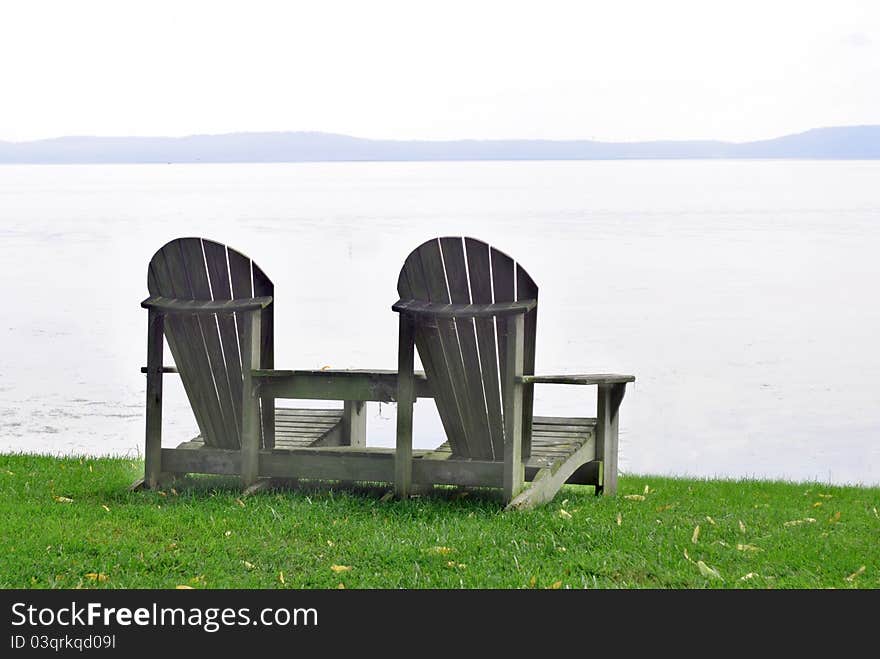 Adirondack Chairs Looking out over the Water. Adirondack Chairs Looking out over the Water