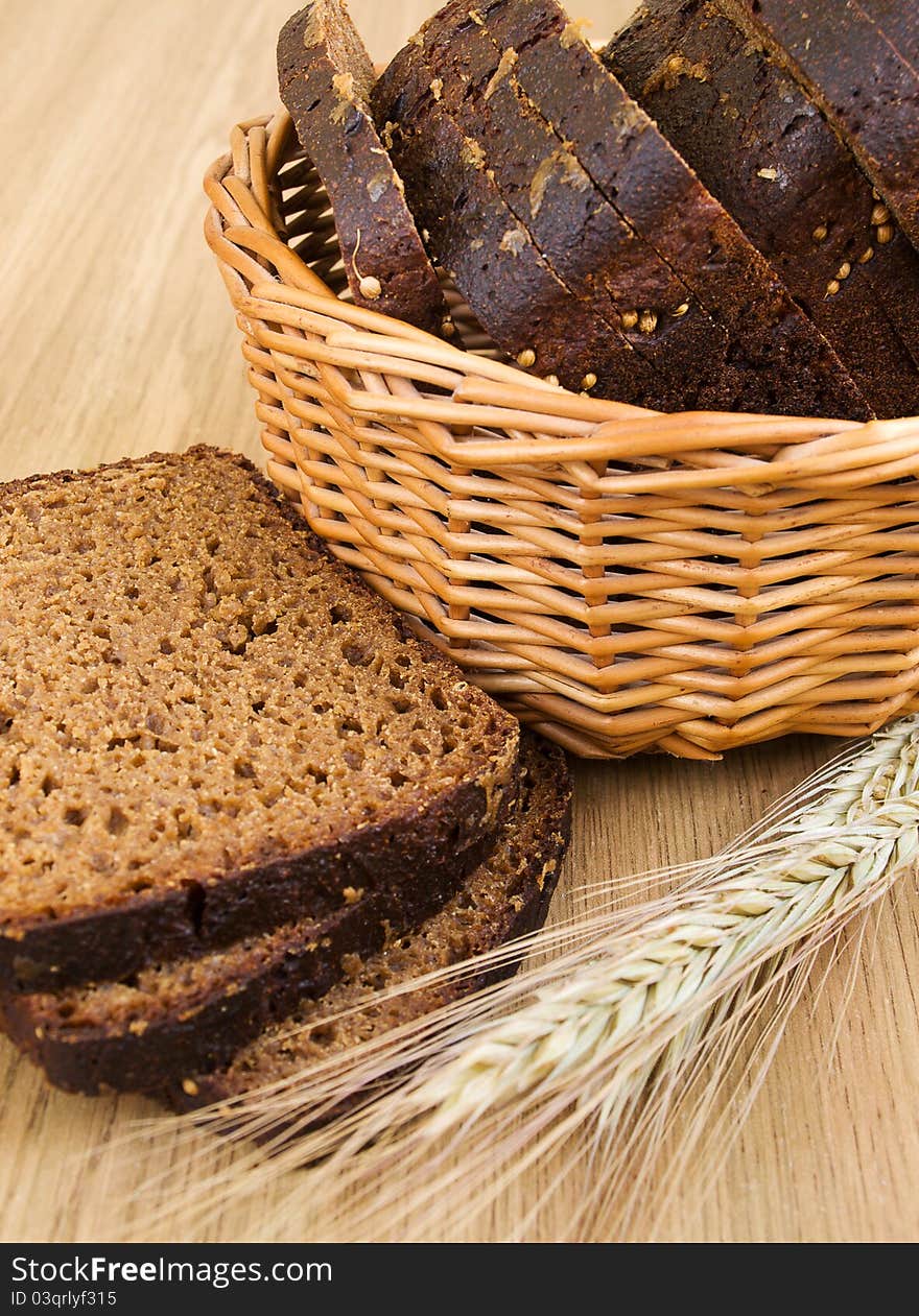 Basket with bread and wheat on the table