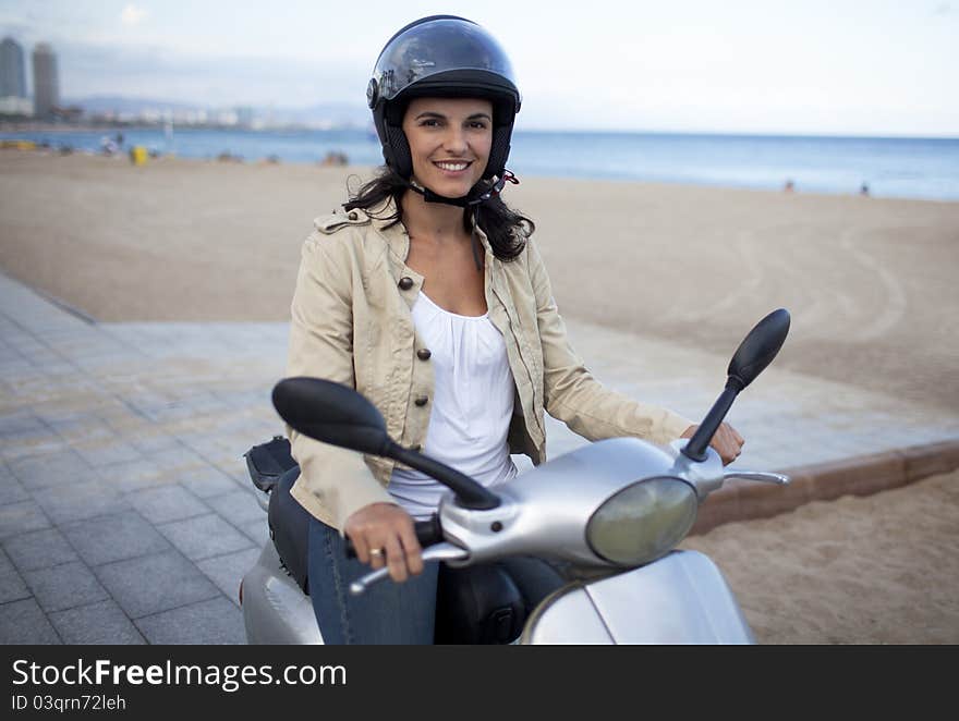 Latin woman on a scooter close to beach. Latin woman on a scooter close to beach