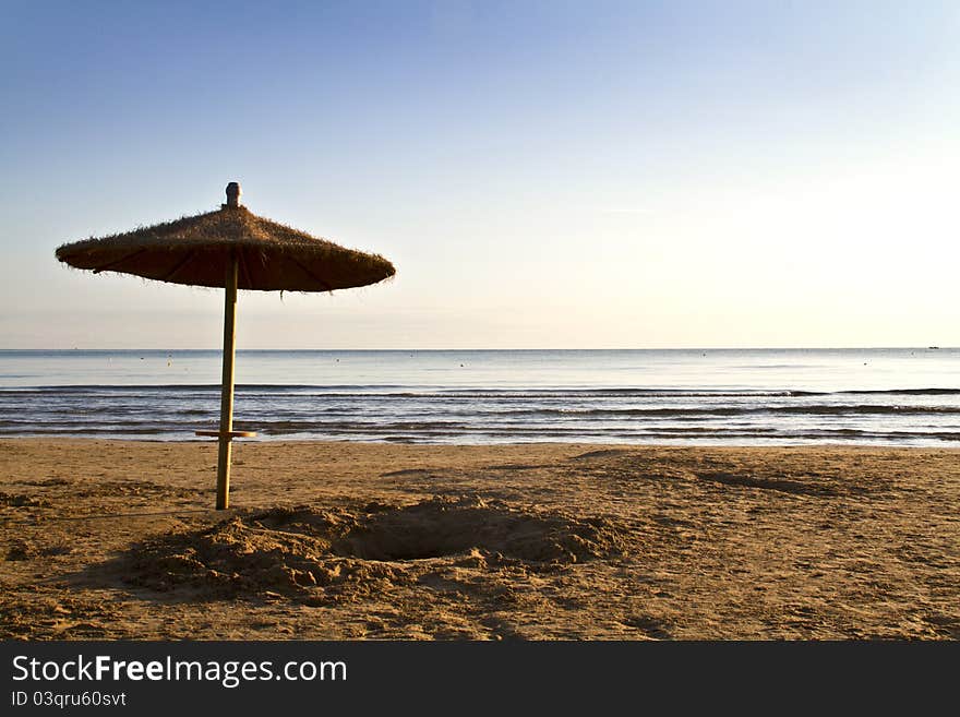 Umbrella on the beach at dawn