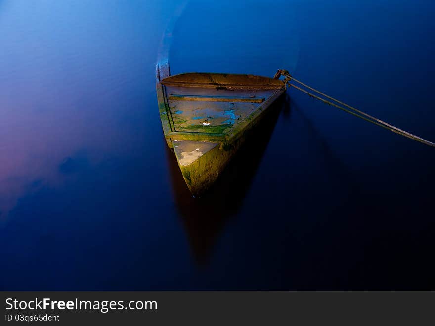 Phantasmagoric scene with sunk boat and dark water. Phantasmagoric scene with sunk boat and dark water