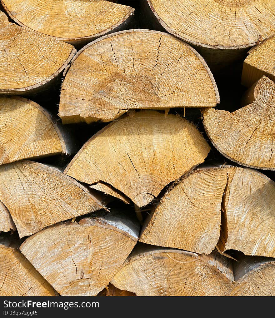 Dry chopped firewood logs stacked up on top of each other in a pile. Dry chopped firewood logs stacked up on top of each other in a pile