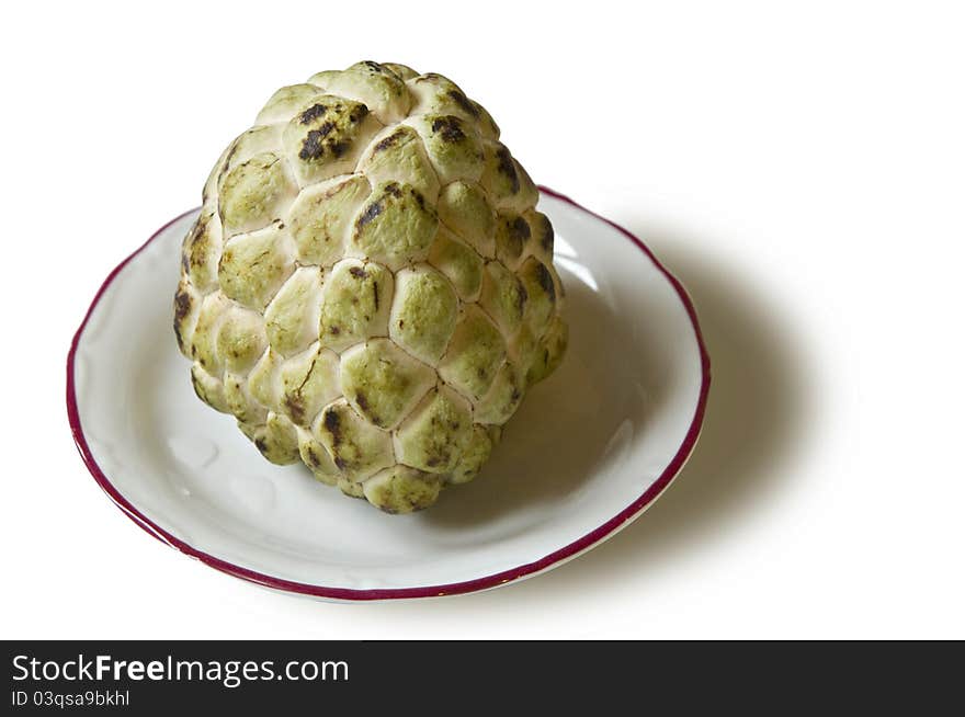 Picture of a ripe custard apple in a small plate. Note: PNG or isolated image is available upon request