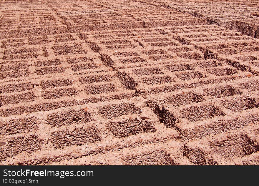 Concrete blocks used to build houses, buildings, office buildings and chimney. Orange red. Composition: cement, sand and lime. Perspective look. Factory of cement blocks. Concrete blocks used to build houses, buildings, office buildings and chimney. Orange red. Composition: cement, sand and lime. Perspective look. Factory of cement blocks