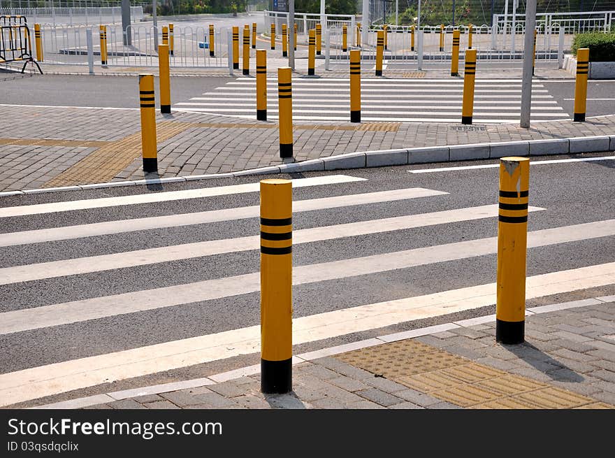 Traffic sign and facilities, such as zebra crossing and side of the road, at road corssing, shown as transportation or construction industrial concept, or way, reach, approach or complicated. Traffic sign and facilities, such as zebra crossing and side of the road, at road corssing, shown as transportation or construction industrial concept, or way, reach, approach or complicated.