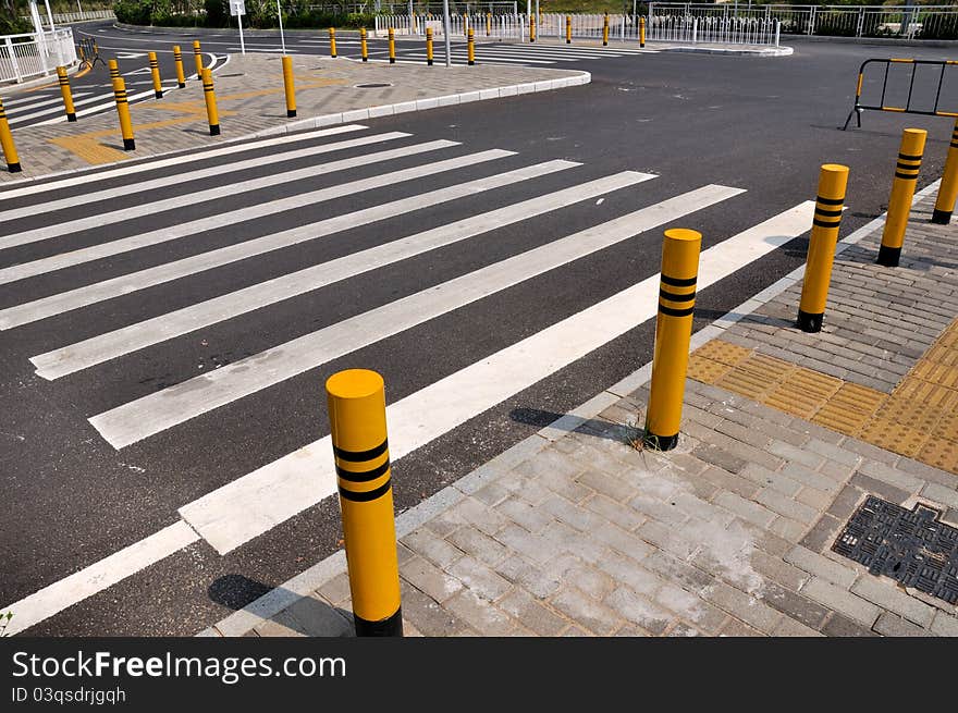 Traffic sign and facilities, such as zebra crossing and side of the road, at road corssing, shown as transportation or construction industrial concept, or way, reach, approach or complicated. Traffic sign and facilities, such as zebra crossing and side of the road, at road corssing, shown as transportation or construction industrial concept, or way, reach, approach or complicated.